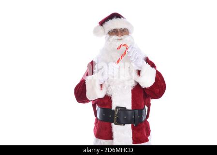 Senior man in traditional Santa Claus costume holding a candy cane in both hands. Isolated on white. Stock Photo