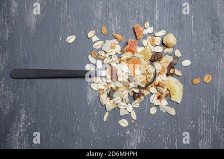 Silver spoon with muesli on gray background Stock Photo