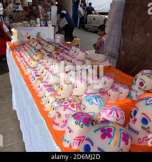 Traditional sugar skulls for sale in Patzcuaro, Mexico, where they are used to decorate altars created to remember the dead during Day of the Dead. Stock Photo