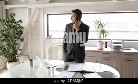 Concentrated young executive ceo manager holding smartphone call. Stock Photo