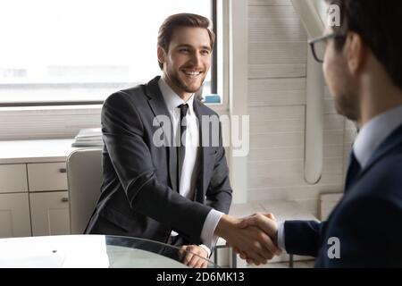 Happy two businessmen celebrating making agreement in office. Stock Photo