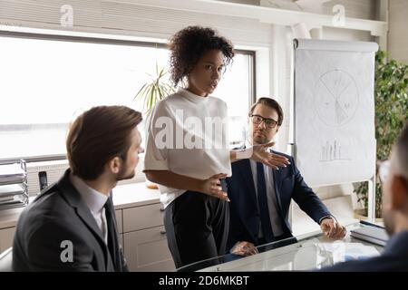 Concentrated young african ethnicity businesswoman providing professional assessment. Stock Photo