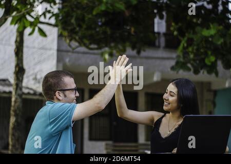 Two young cheerful students celebrating after their successful studying session Stock Photo