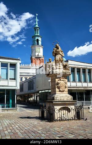 The historic figure of St. John of Nepomuk and the town hall tower in the market square in Poznan