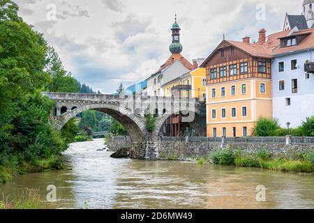 Arch bridge over river Mur in historic town of Murau in central eastern Alps, Austria Stock Photo