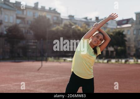 Beautiful female warming up before morning training Stock Photo