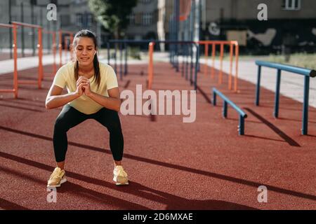 Fit woman doing deep squats Stock Photo - Alamy