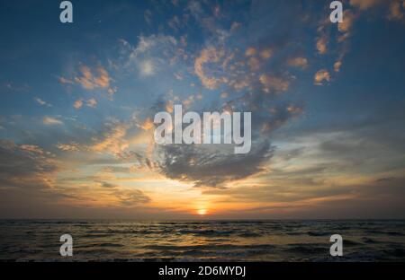 Sunrise over the sea and beautiful cloudscape Stock Photo