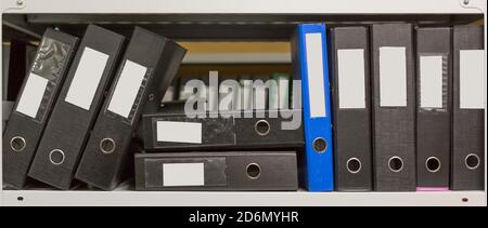 A few of archive folders in the office shelf. papers, documents and catalogs. Stock Photo