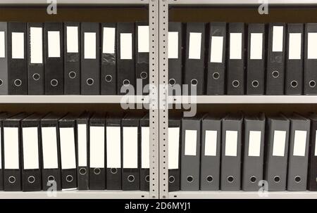 A lot of folders in the archive shelf: papers, documents and catalogs. Stock Photo