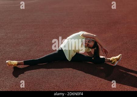 Active woman doing aerobic exercises in twine position Stock Photo