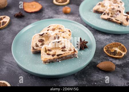 Christstollen, traditonal christmas cake with nuts, raisons, marzipan on a blue background, empty space for text Stock Photo