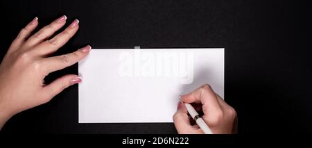 Female hands writing on white paper with vitage pen with copy space Stock Photo