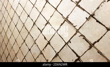 Tile wall. Old white tiles background. Ancient ceramic small square tiles for indoor and outdoor use with glossy and matte finish Stock Photo
