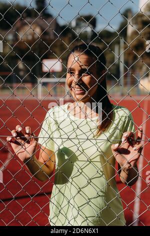 Happy fit woman posing on camera at stadium Stock Photo
