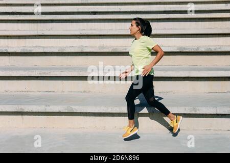 Active fitness woman in sport outfit jogging outdoors Stock Photo