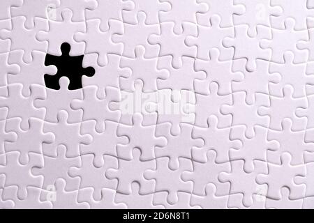 White puzzle and one missing puzzle piece Stock Photo
