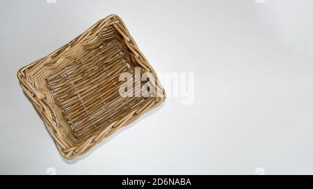 Wicker wooden basket for storing food or household items isolated on a white background with space for text. Template. Stock Photo