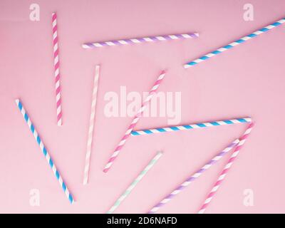 Drinking paper straws for cocktails on pink background. Paper disposable eco-friendly straws. Stock Photo