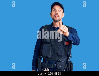 Young handsome man wearing police uniform pointing displeased and frustrated to the camera, angry and furious with you Stock Photo