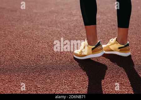Young active woman in sneakers doing morning workout Stock Photo