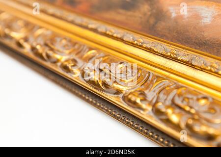 Ancient vintage golden frame fragment, wooden carving close-up photo with selective focus Stock Photo