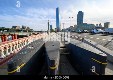 Blackfriars road bridge in London with Anti-terrorism bollards. Blackfriars railway bridge to left. One Blackfriars and Southbank Tower behind. Stock Photo