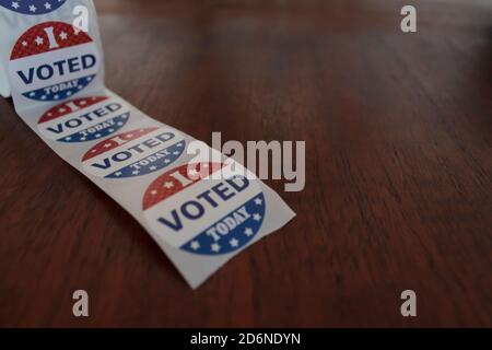 Roll of I Voted Today stickers for voters in the US elections on wooden table Stock Photo