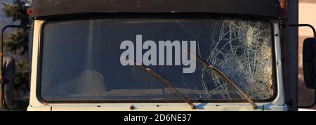 Broken windshield of a truck (lorry). Accident and traffic accident. The crash. A gunshot attack on a car. Abandoned truck after an accident Stock Photo
