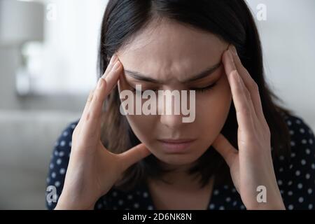 Unhealthy asian girl suffer from headache or migraine Stock Photo