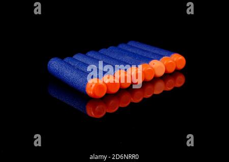 Toy gun bullets made from foam and rubber isolated on the black background Stock Photo