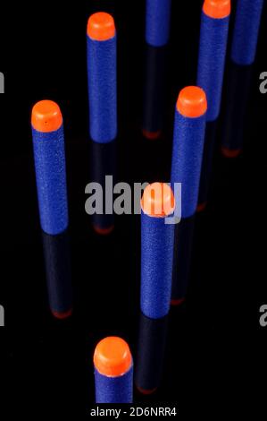 Toy gun bullets made from foam and rubber isolated on the black background Stock Photo