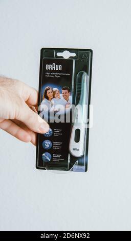 Paris, France - Mar 14, 2018: POV male hand holding Braun high speed thermomether Stock Photo