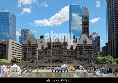 TORONTO, CANADA - 06 27 2016: View across the fountain on Nathan Phillips Square with Old City Hall and Cadillac Fairview Tower in the background Stock Photo