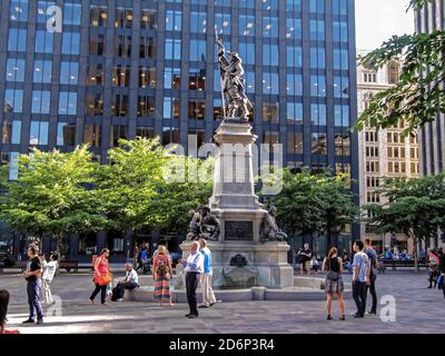 MONTREAL, CANADA - 06 24 2016: The Maisonneuve Monument in front of 500 Place d'Armes building in heart of Montreal. It is a monument in memory of Stock Photo