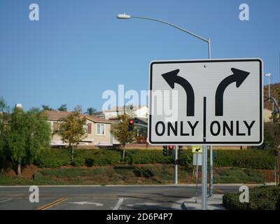 Turn Only Road Sign with intersection in background Stock Photo