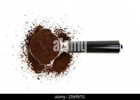 Black and silver coffee filter piled high with ground coffee top down view Stock Photo