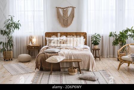 https://l450v.alamy.com/450v/2d6p6wy/rustic-home-design-with-ethnic-boho-decoration-bed-with-pillows-wooden-furniture-2d6p6wy.jpg