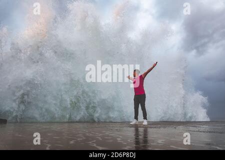Young caucasian man posing at a sea port. Stock Photo