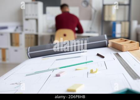 Background image of architects workplace with blueprints and tools on drawing table in foreground, copy space Stock Photo