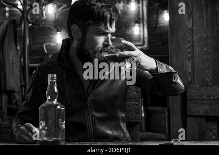 Man with beard holds glass brandy. Degustation, tasting. Handsome bearded man. Do not drink and drive. Stock Photo