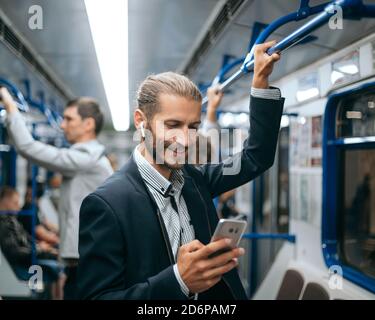 young man reading his correspondence in the subway . Stock Photo