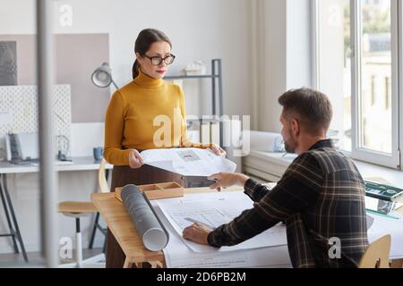 Portrait of two architects discussing blueprints while working together at desk in office , copy space Stock Photo