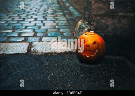 Horror pumpkin in old town . Scary street with  Jack-o'-lantern Stock Photo