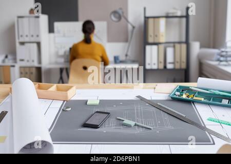 Background image of blueprints and plans on drawing desk at architects workplace, copy space Stock Photo