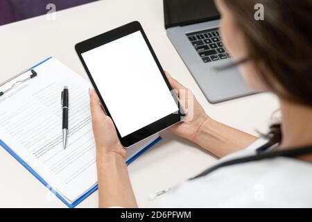 Mockup on tablet with female doctor wear headset make online video call. Stock Photo
