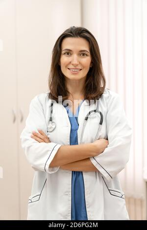 Vertical portrait of smiling young female doctor looking at the camera. Stock Photo