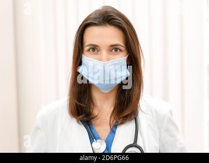 Vertical portrait of confident young female doctor looking at the camera. Stock Photo
