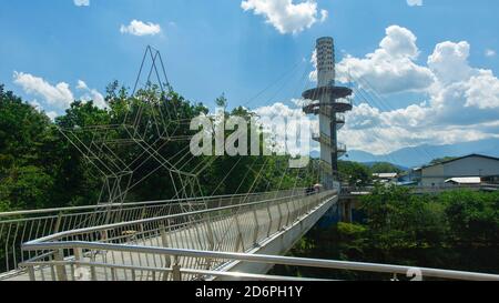 Tena, Napo / Ecuador - October 10 2020: People walking on the bridge over the Napo river near the city lookout tower in the Ecuadorian Amazon Stock Photo