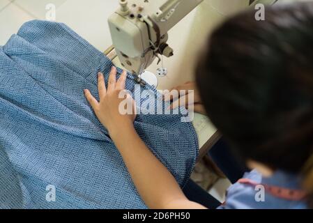 top view of women tailors working with sewing machines in the garment convection production room Stock Photo
